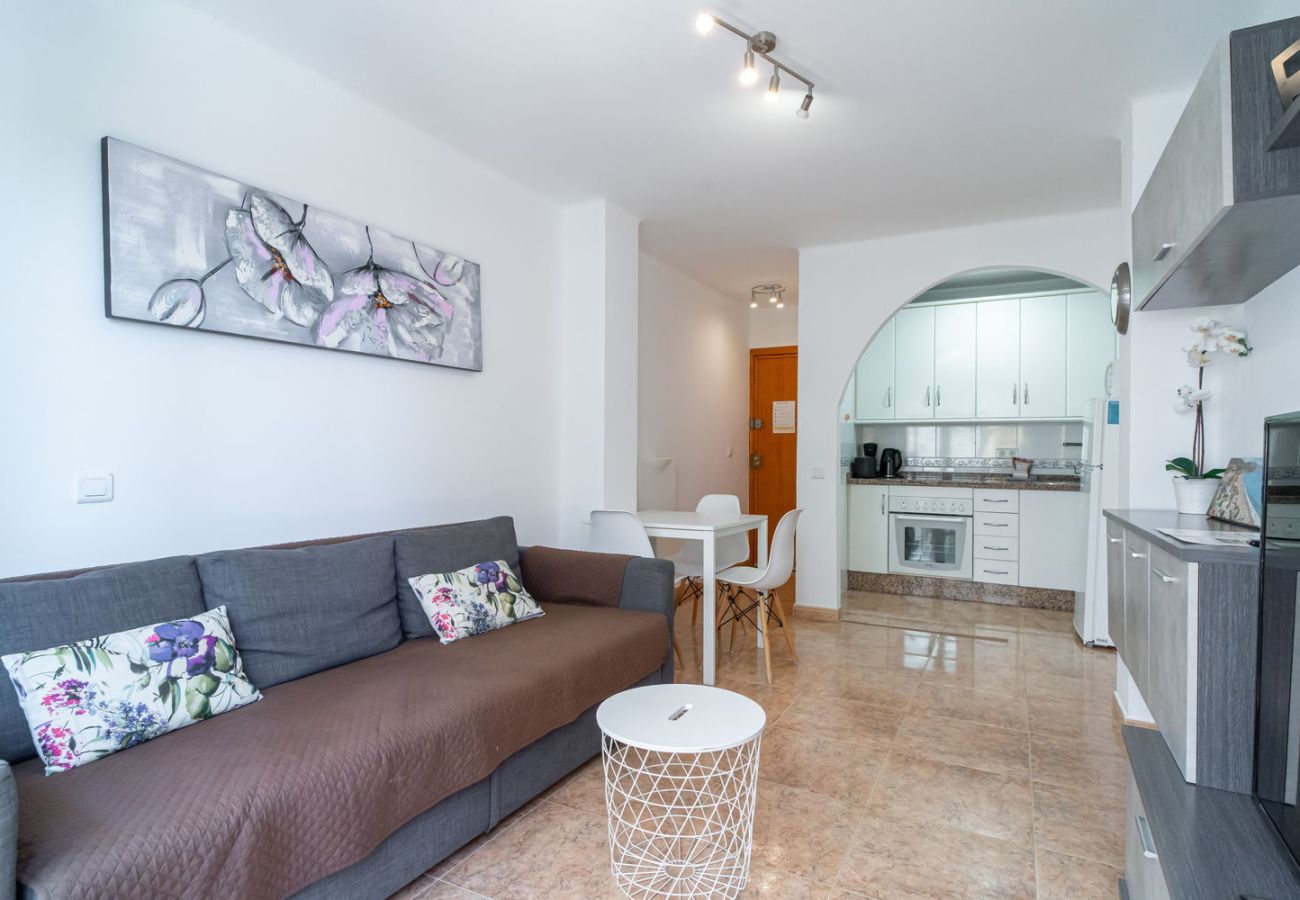 Open woon-eetkamer met geïntegreerde keuken in vakantieappartement in Nerja.